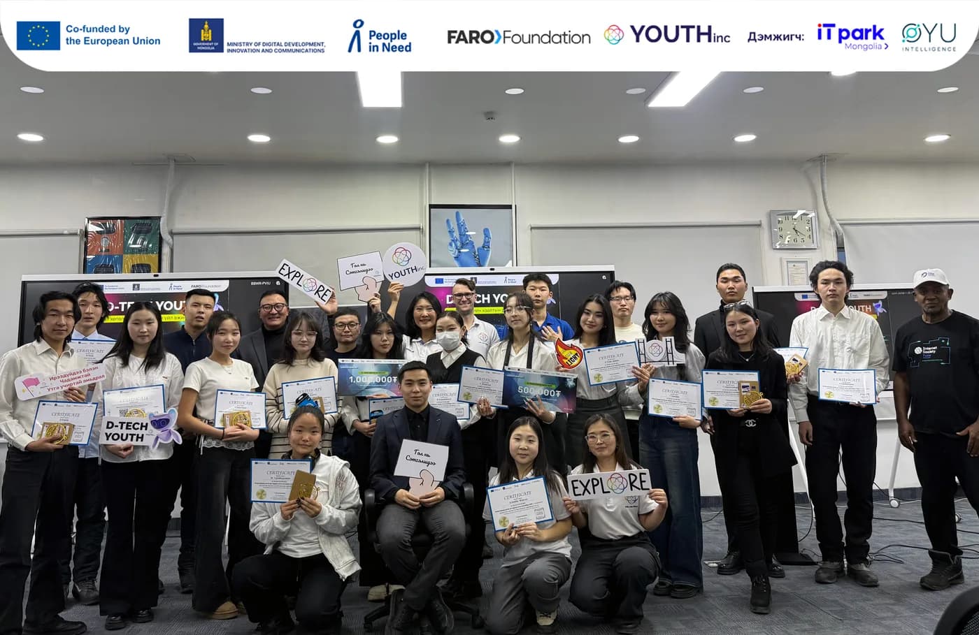 Graduates with certificates and mentors at the D-Tech Youth closing ceremony