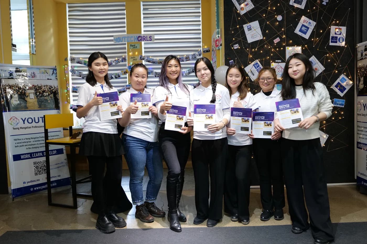 Participants holding their certificates after the hackathon