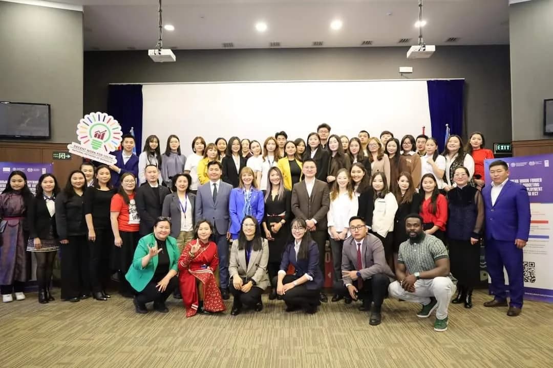 Large group of participants and organisers in a conference hall